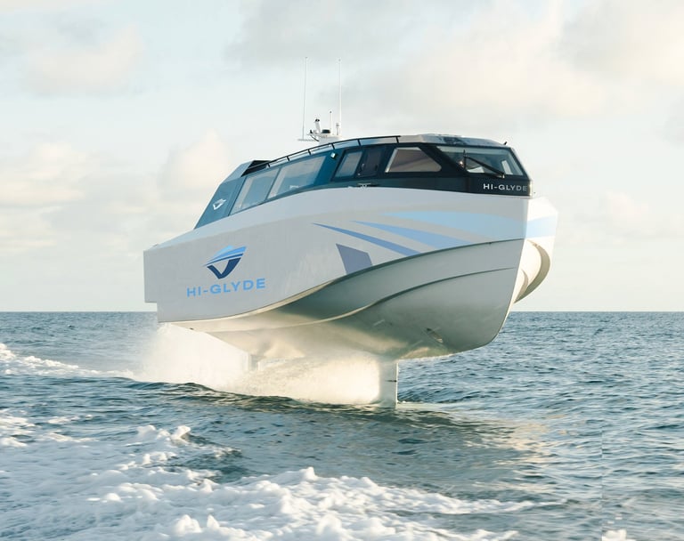 High-speed motor yacht HI-GLYDE beached in shallow ocean waves with blue and white hull design