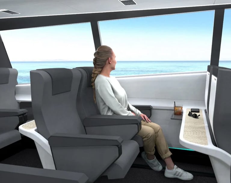 Woman sitting in gray seat inside a boat or ferry cabin, looking out at the ocean through large windows